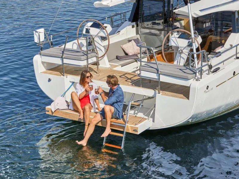 Slide: The Image of Couple relaxing on a 2025 Moody 41 DS yacht, enjoying a sunny day on the water. - 15