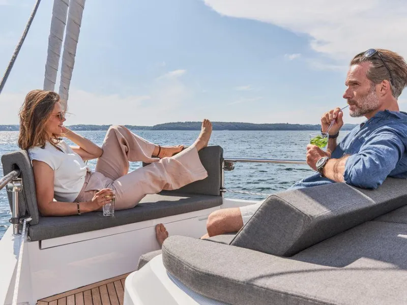 Slide: The Image of Couple relaxing on a 2025 Moody 41 DS yacht, enjoying a sunny day at sea. - 17