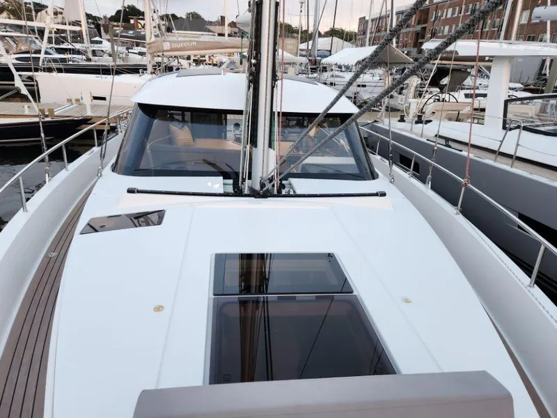 Slide: The Image of 2025 Moody 41 DS sailboat deck with sleek design and modern features at a marina. - 21
