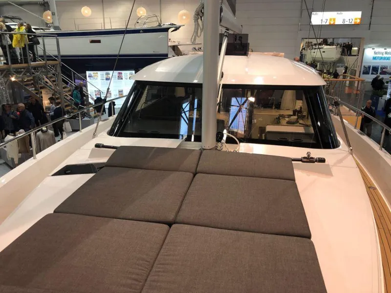 Slide: The Image of 2025 Moody 41 DS yacht with cushioned deck, showcased indoors. - 23