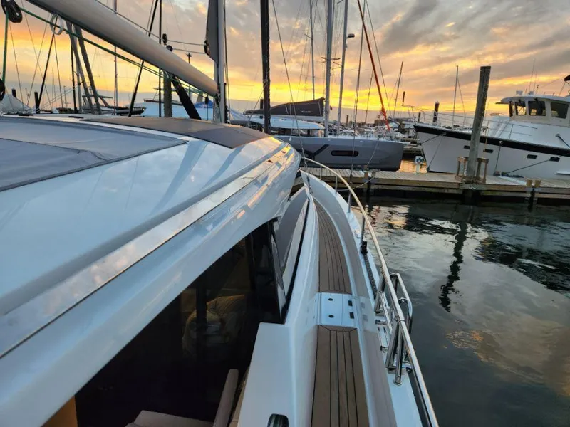 Slide: The Image of 2025 Moody 41 DS yacht docked at sunset, showcasing sleek design and marina setting. - 25