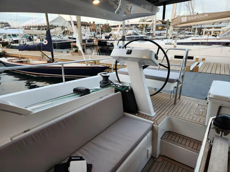Slide: The Image of Modern 2025 Moody 41 DS yacht cockpit with steering wheel, docked at marina. - 32