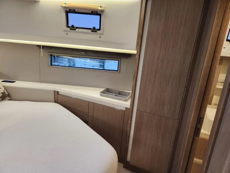 Slide: The Image of Luxurious interior of 2025 Moody 41 DS yacht with modern wood finishes and cozy bedding. - 36