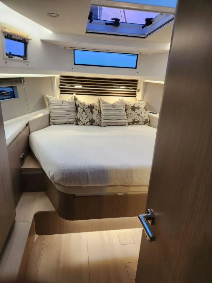 Slide: The Image of Luxurious cabin interior of 2025 Moody 41 DS yacht with skylight and plush bedding. - 37