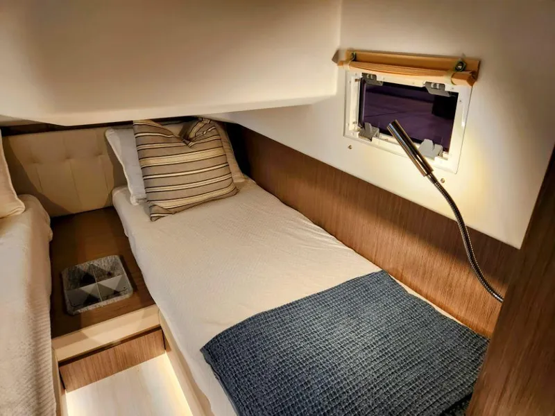 Slide: The Image of Cozy cabin interior of 2025 Moody 41 DS yacht with single bed and reading light. - 40