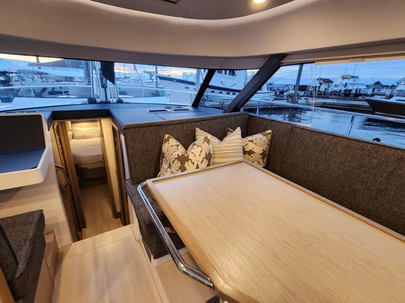 Slide: The Image of Luxurious interior of 2025 Moody 41 DS yacht with elegant dining area and marina view. - 45