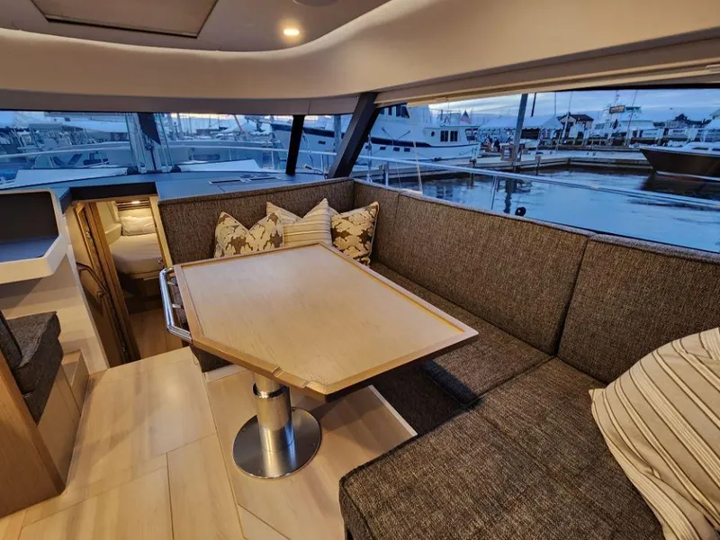 Slide: The Image of Interior of 2025 Moody 41 DS yacht with cozy seating and marina view. - 46