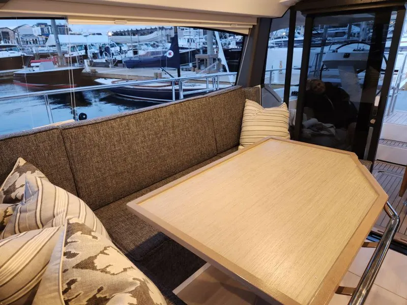 Slide: The Image of Luxurious interior of 2025 Moody 41 DS yacht with elegant seating and marina view. - 49