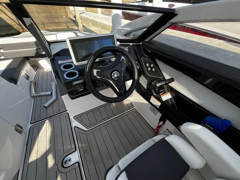 Slide: The Image of 2023 Yamaha Boats 275 SDX cockpit with modern steering and touchscreen display. - 11