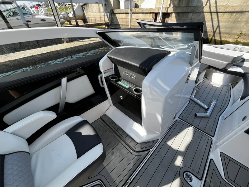 Slide: The Image of 2023 Yamaha Boats 275 SDX interior with sleek seating and modern dashboard design. - 12