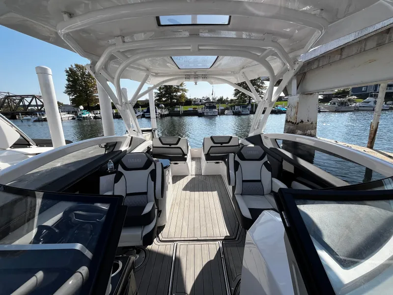 Slide: The Image of 2023 Yamaha Boats 275 SDX interior with sleek seating and open deck design. - 15
