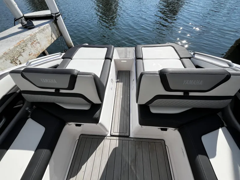 Slide: The Image of 2023 Yamaha Boats 275 SDX interior seating with water view. - 16