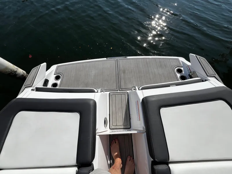 Slide: The Image of 2023 Yamaha Boats 275 SDX swim platform with sunlit water view. - 17