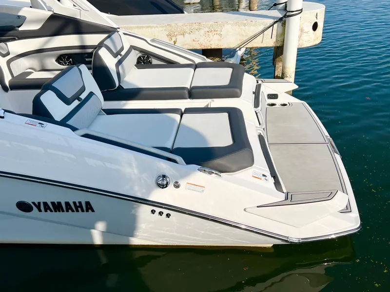 Slide: The Image of 2023 Yamaha Boats 275 SDX, sleek design, luxury seating, docked on calm water. - 6