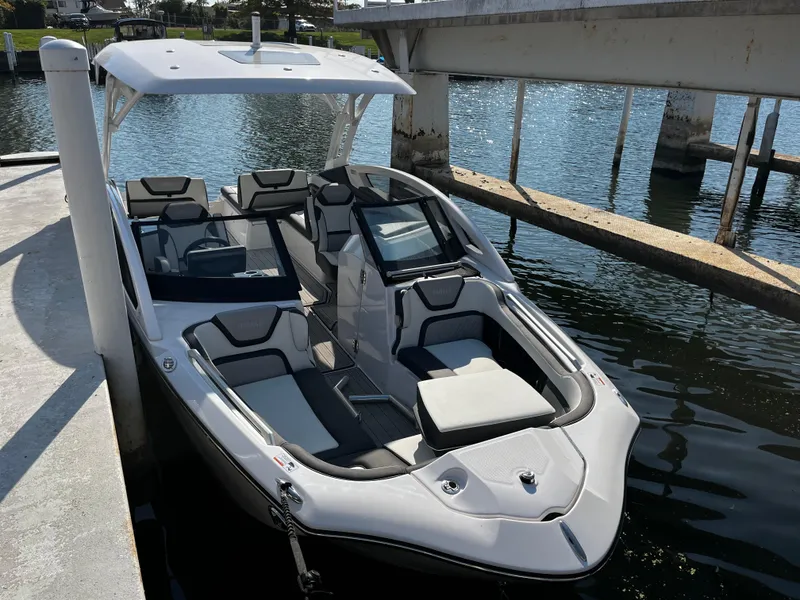 Slide: The Image of 2023 Yamaha Boats 275 SDX docked, sleek design, spacious seating, modern features. - 7
