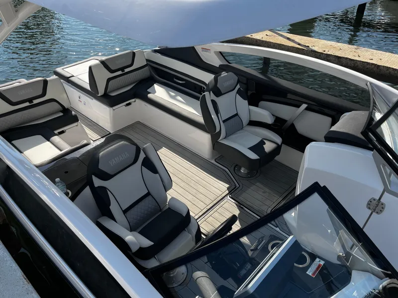 Slide: The Image of 2023 Yamaha Boats 275 SDX interior with luxurious seating and modern design. - 8