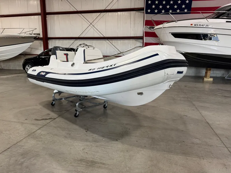 Slide: The Image of 2018 AB Inflatables Nautilus 12 DLX boat in showroom with American flag backdrop. - 1