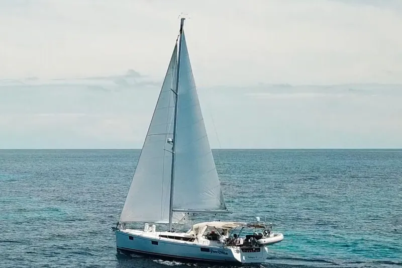 The Image of 2013 Beneteau Oceanis 48 sailing on open sea under clear skies. - 0