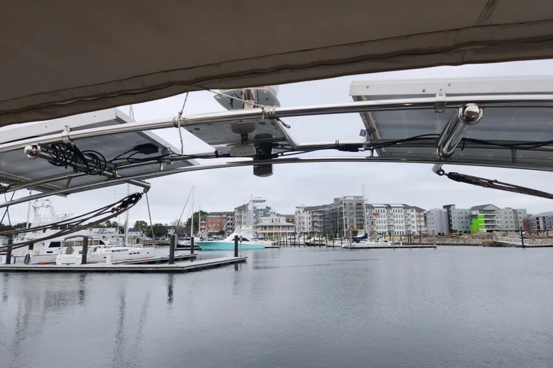 Slide: The Image of View from a 2013 Beneteau Oceanis 48 sailboat in a marina with modern buildings. - 13