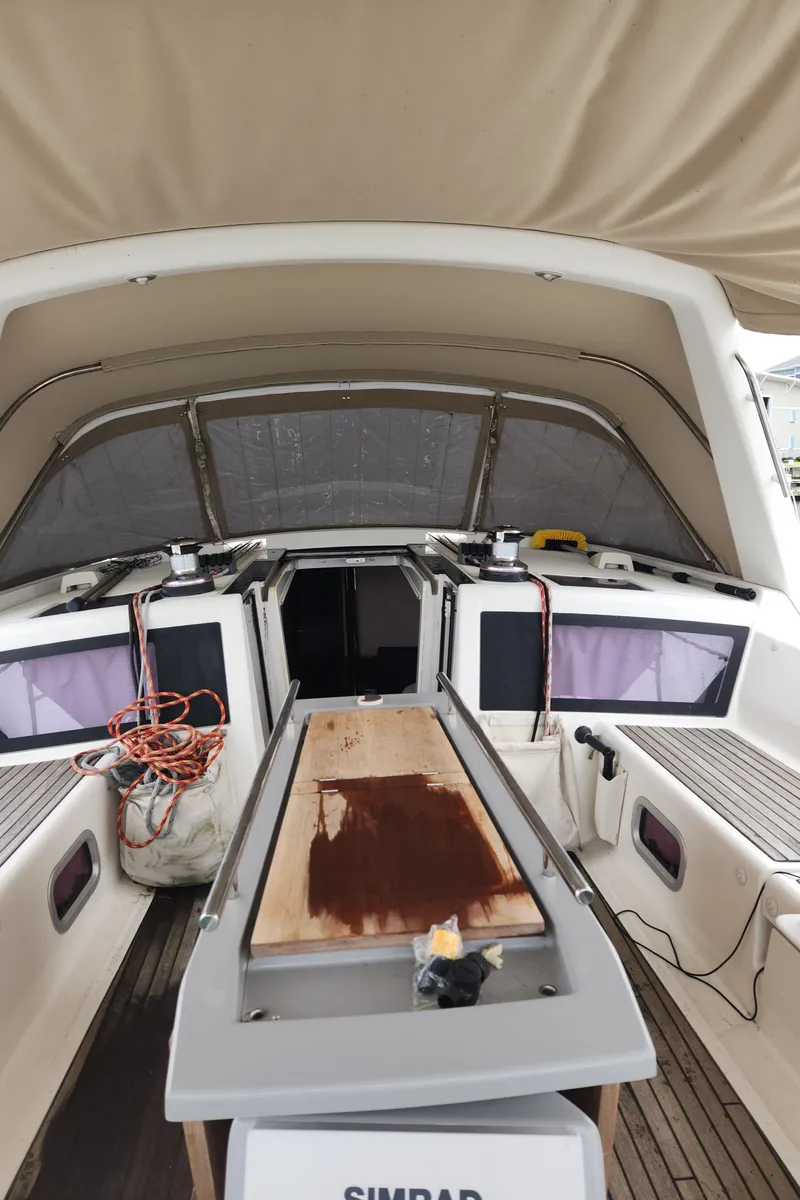 Slide: The Image of 2013 Beneteau Oceanis 48 yacht cockpit with covered seating and equipment. - 16