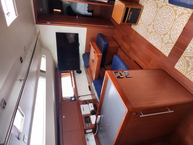 Slide: The Image of Interior of 2013 Beneteau Oceanis 48 yacht with modern furnishings and wood finish. - 19