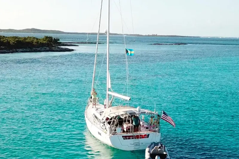 Slide: The Image of Beneteau Oceanis 48 sailboat, 2013 model, anchored in clear turquoise waters. - 2