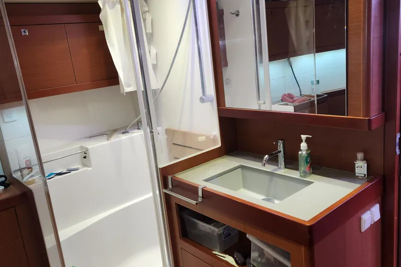 Slide: The Image of Bathroom interior of 2013 Beneteau Oceanis 48 yacht with modern fixtures and wooden cabinetry. - 22