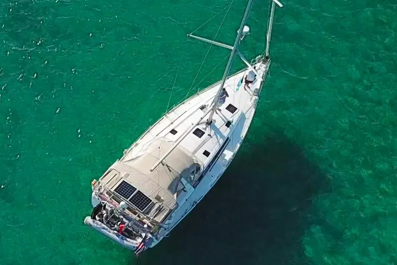 Slide: The Image of Aerial view of 2013 Beneteau Oceanis 48 sailboat on clear turquoise water. - 4