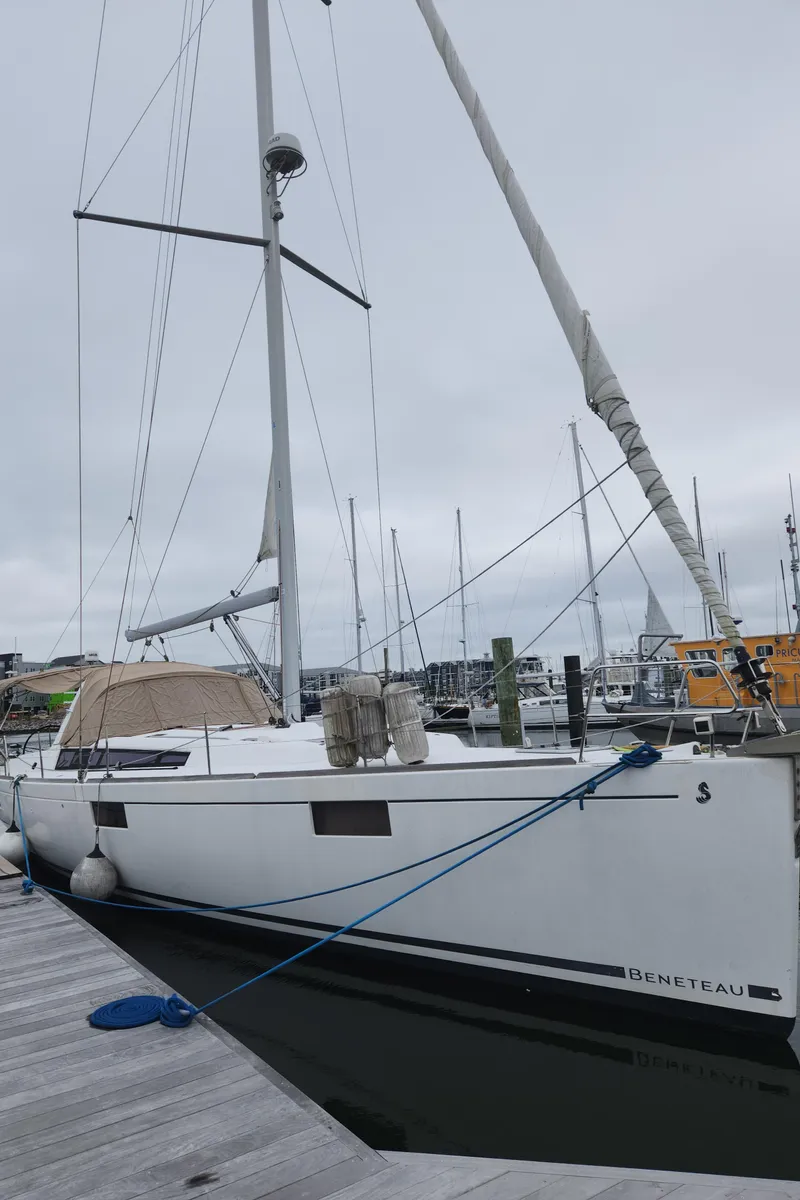 Slide: The Image of 2013 Beneteau Oceanis 48 sailboat docked at a marina on a cloudy day. - 6