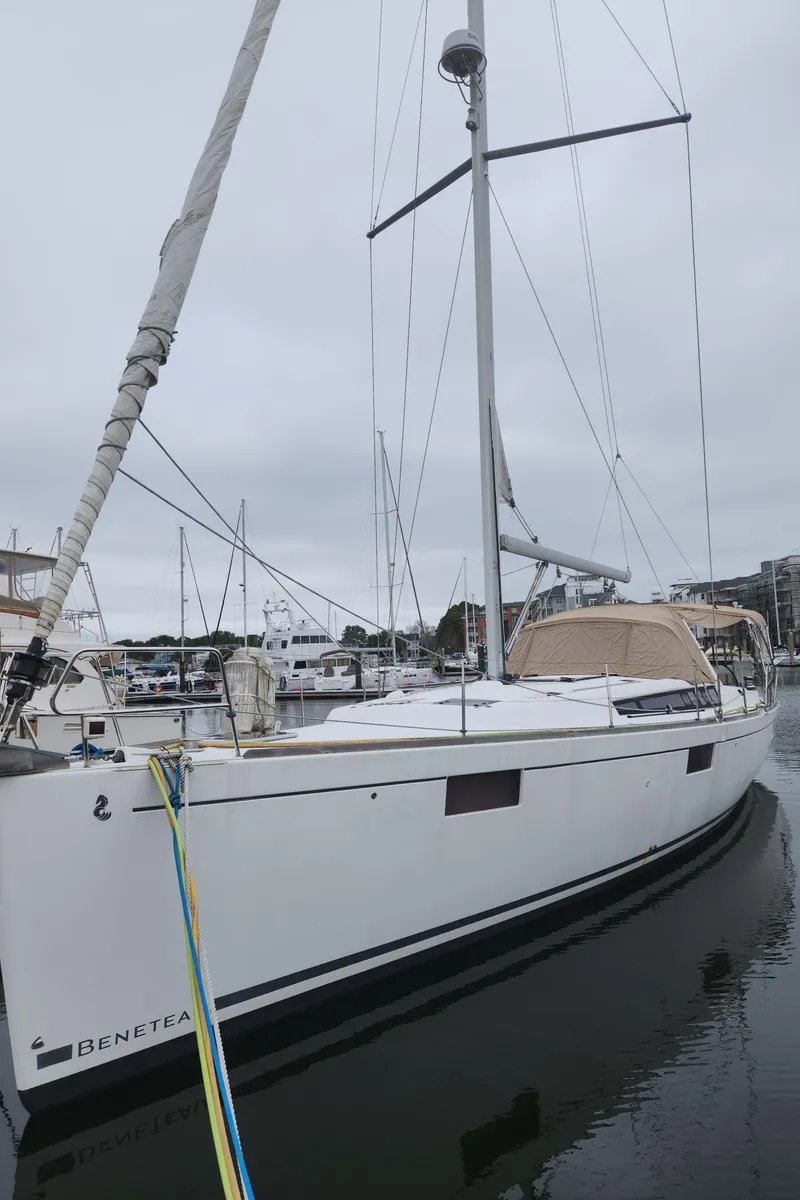 Slide: The Image of 2013 Beneteau Oceanis 48 sailboat docked in marina, overcast sky. - 7