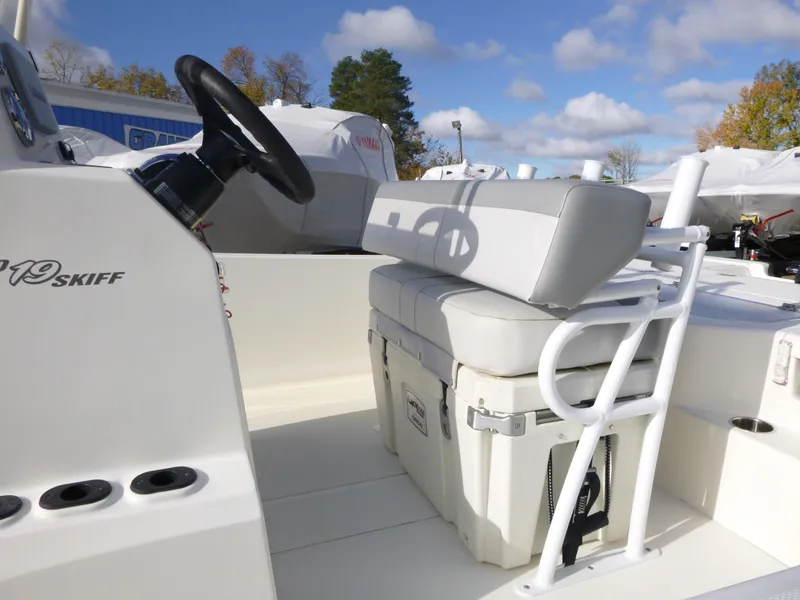 Slide: The Image of 2022 Mako 19CC boat interior with steering wheel and cushioned seating. - 11