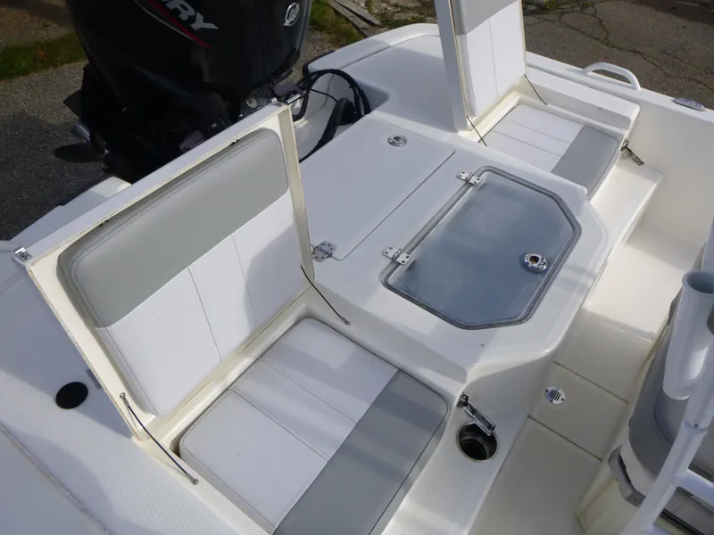 Slide: The Image of 2022 Mako 19CC boat interior with seating and storage compartments. - 16