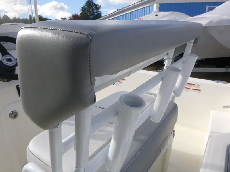 Slide: The Image of 2022 Mako 19CC boat seat with rod holders, outdoor setting. - 18
