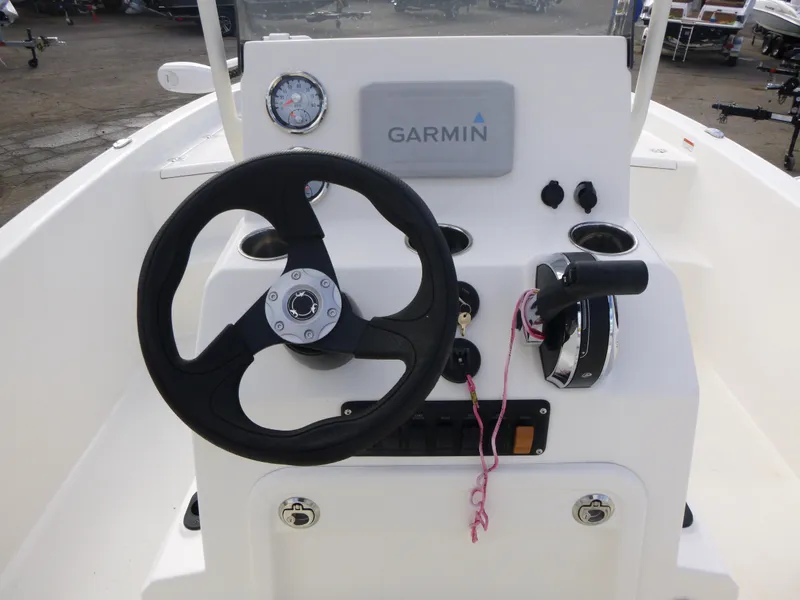 Slide: The Image of 2022 Mako 19CC boat console with Garmin navigation system and steering wheel. - 20