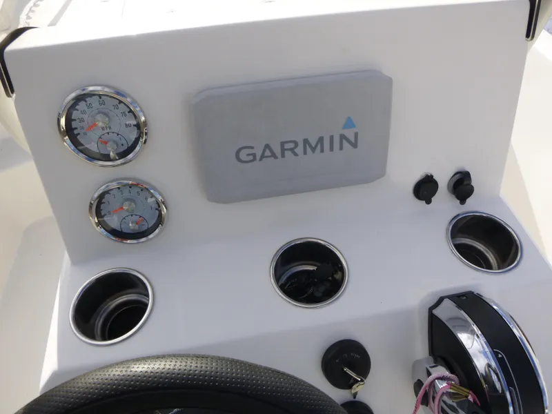 Slide: The Image of 2022 Mako 19CC boat dashboard with Garmin display and gauges. - 21