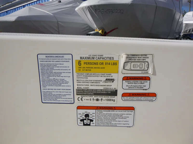 Slide: The Image of Capacity and safety labels on a 2022 Mako 19CC boat, showing maximum load and warnings. - 26