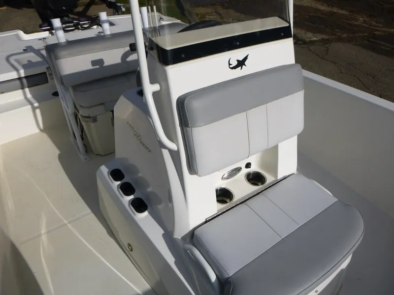 Slide: The Image of 2022 Mako 19CC boat interior with cushioned seating and cup holders. - 27