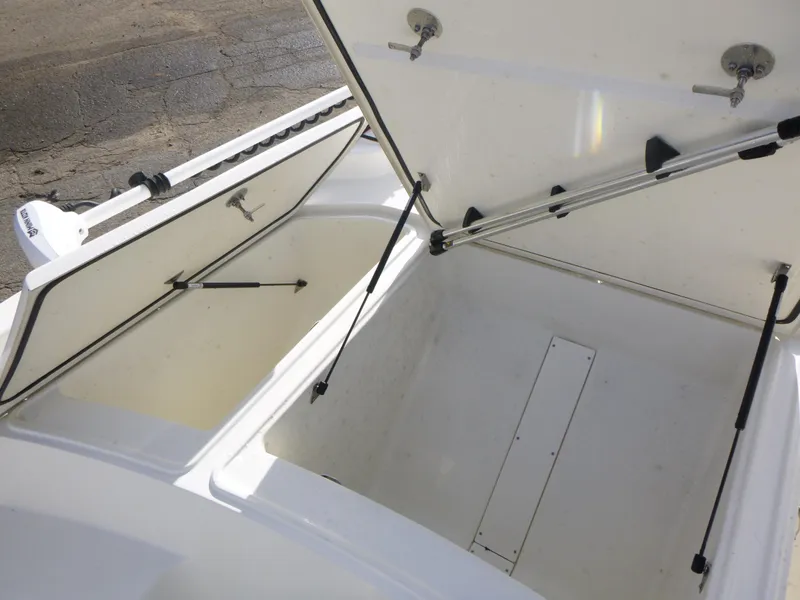 Slide: The Image of Open storage compartments on a 2022 Mako 19CC boat. - 29