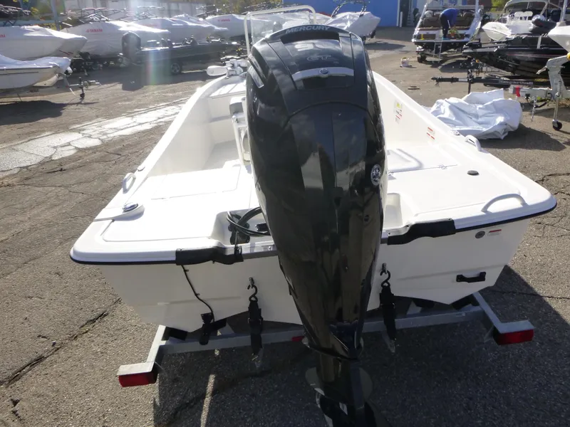 Slide: The Image of 2022 Mako 19CC boat with outboard motor on trailer in a marina. - 4