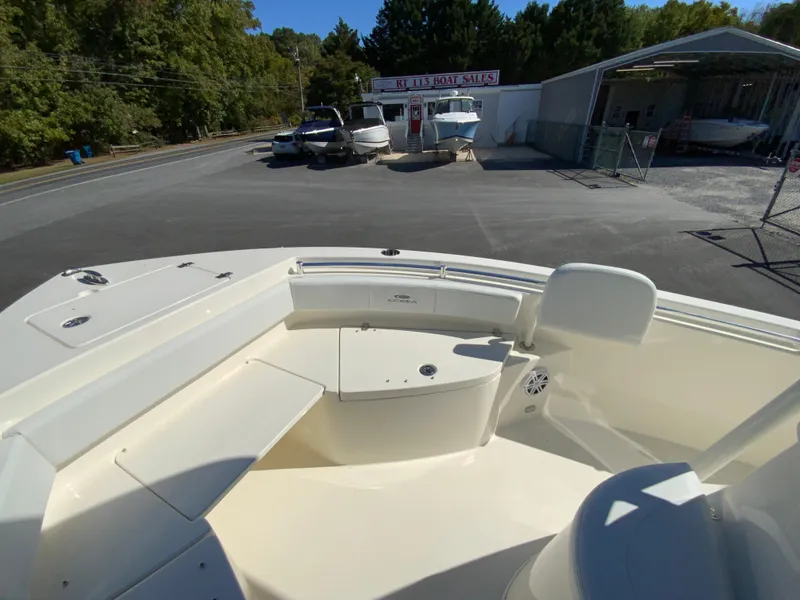 Slide: The Image of 2025 Cobia 220 Center Console boat interior at a dealership lot. - 10