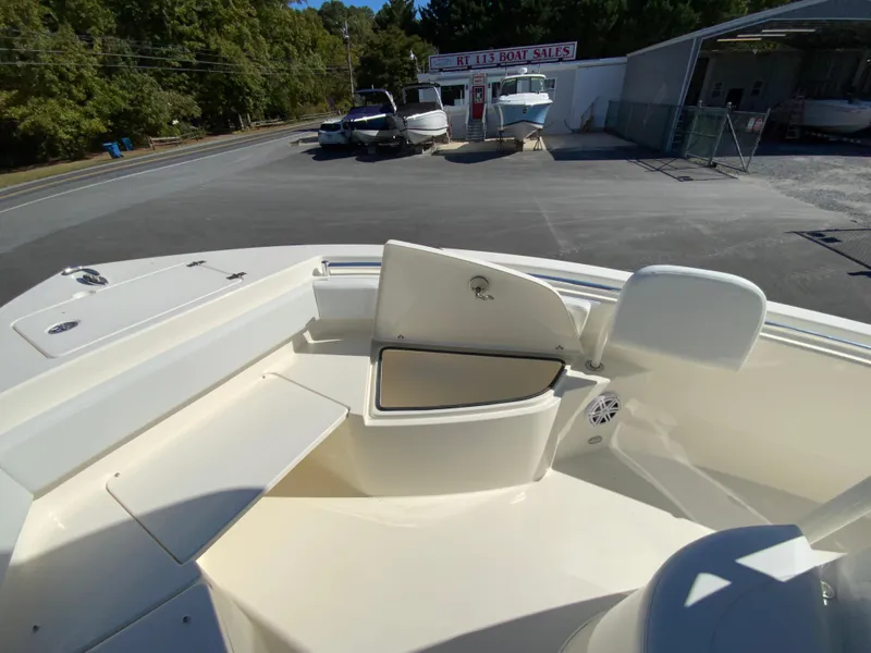 Slide: The Image of 2025 Cobia 220 Center Console boat interior with open storage compartment. - 11