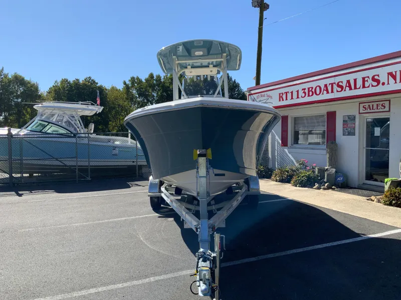 Slide: The Image of 2025 Cobia 220 Center Console boat on trailer at dealership. - 2