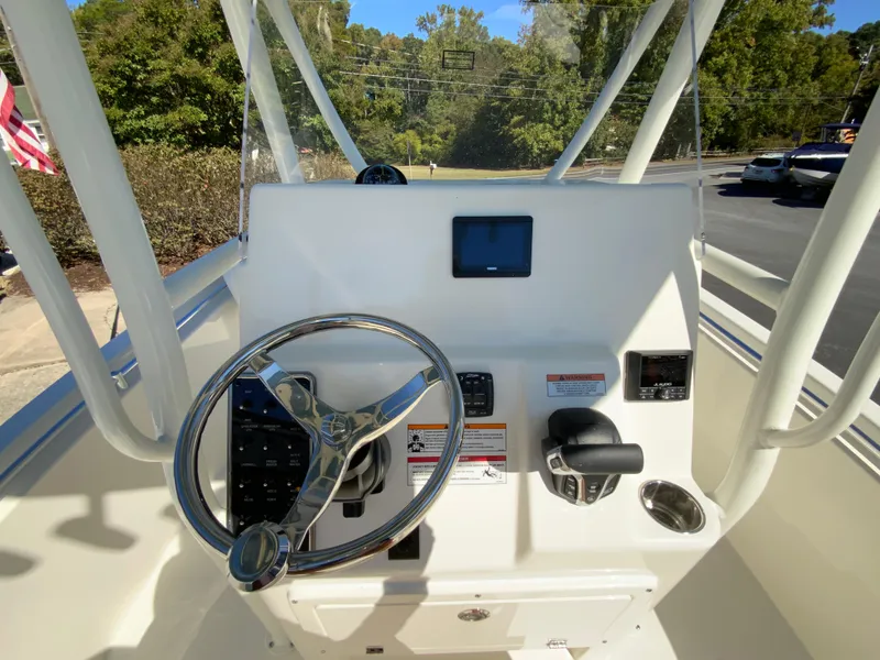 Slide: The Image of 2025 Cobia 220 Center Console boat dashboard with steering wheel and controls. - 24