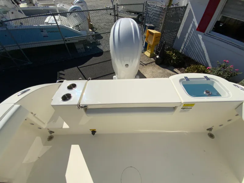 Slide: The Image of 2025 Cobia 220 Center Console boat deck with motor and fishing amenities. - 29