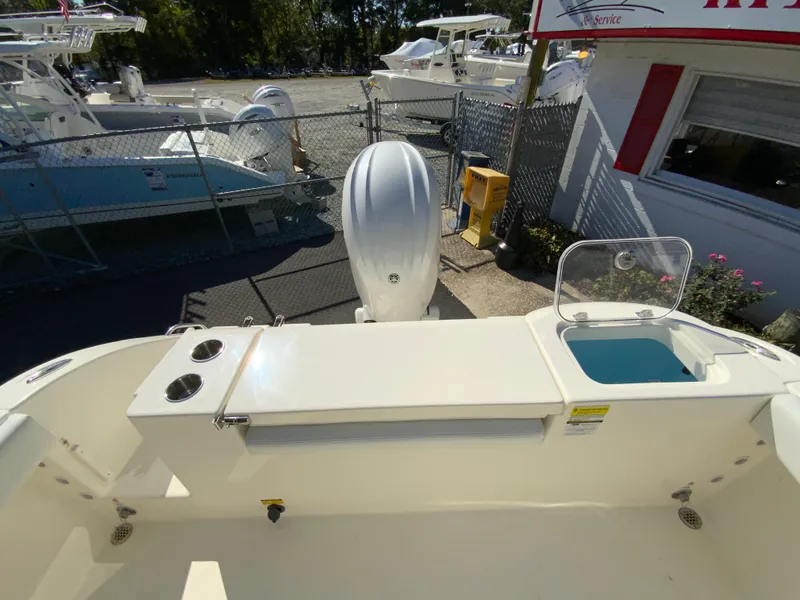 Slide: The Image of 2025 Cobia 220 Center Console boat interior with motor and storage area. - 31