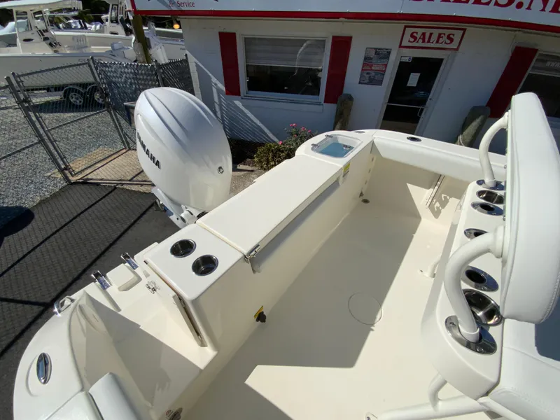 Slide: The Image of 2025 Cobia 220 Center Console boat interior with Yamaha engine at sales lot. - 32