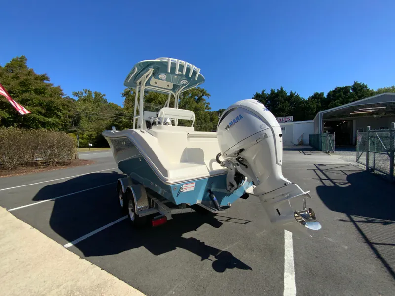 Slide: The Image of 2025 Cobia 220 Center Console boat with Yamaha outboard in parking lot. - 5