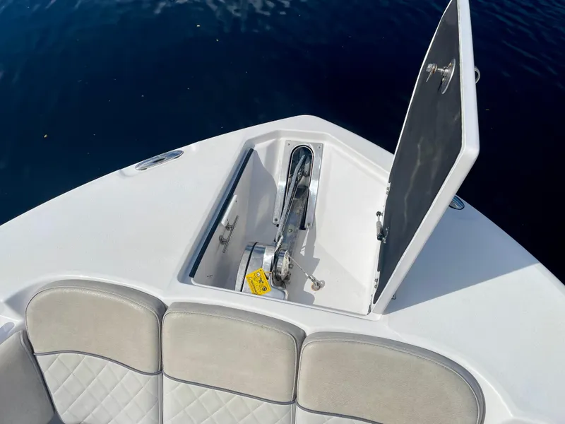 Slide: The Image of 2019 Sea Fox 288 Commander anchor compartment with open hatch, showing seating and water background. - 1