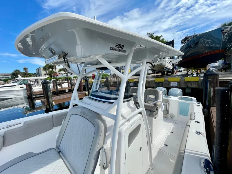 Slide: The Image of 2019 Sea Fox 288 Commander boat docked, featuring a sleek design and spacious deck. - 10