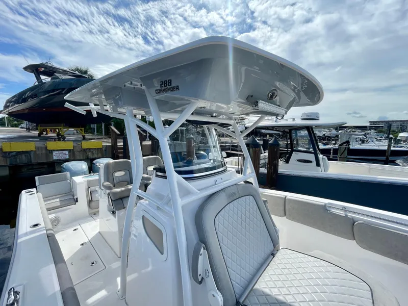 Slide: The Image of 2019 Sea Fox 288 Commander boat at marina, featuring sleek design and spacious seating. - 11